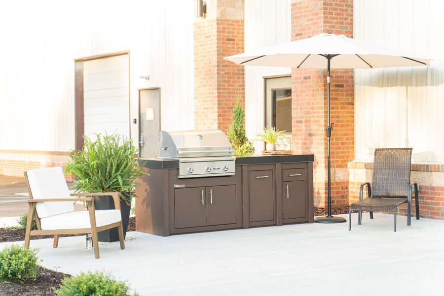 Bright picture showing an outdoor kitchen with an umbrella