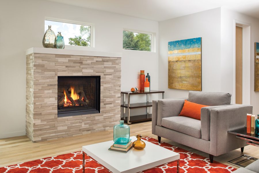 Fireplace insert in a brightly decorated room with an orange rug and comfortable furniture