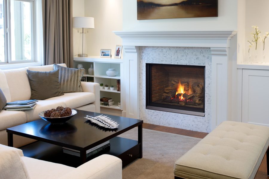 White fireplace insert in a living room with white walls and furniter