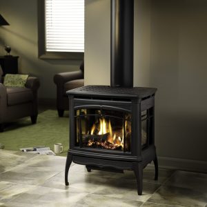 Gas stove in a dimly lit room with grey walls and a tile floor