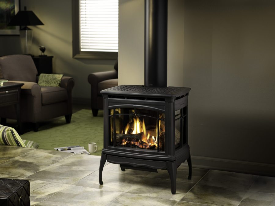 Gas stove in a dimly lit room with grey walls and a tile floor