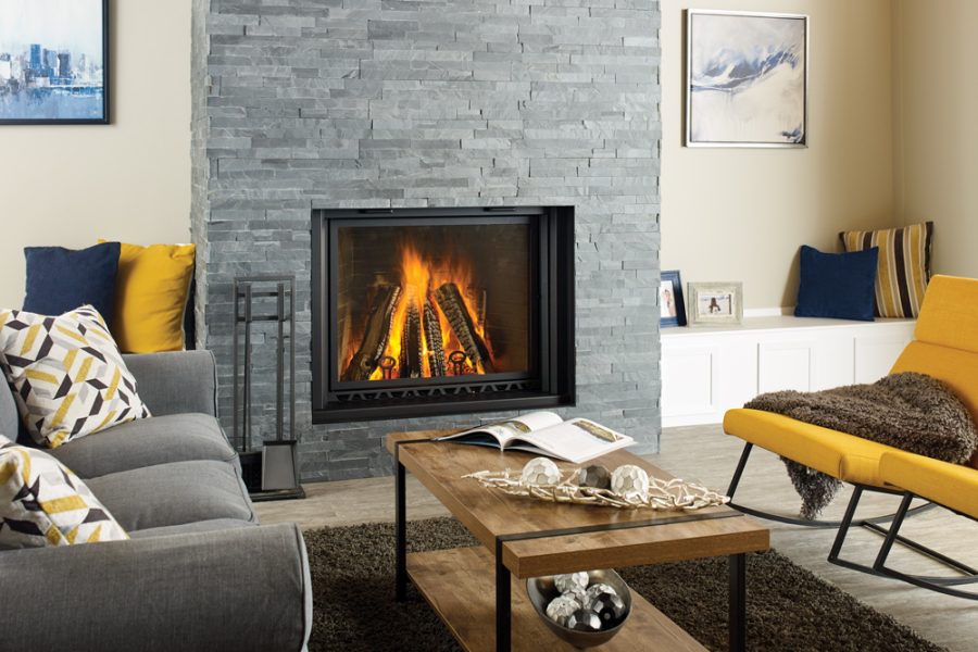 Wood fireplace in a small living room with comfortable seating