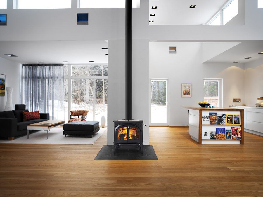 Black woodstove in a large living room with modern decorations