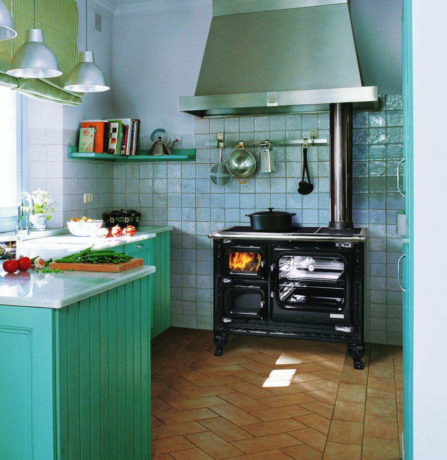 Oven in a green kitchen with tile and a window