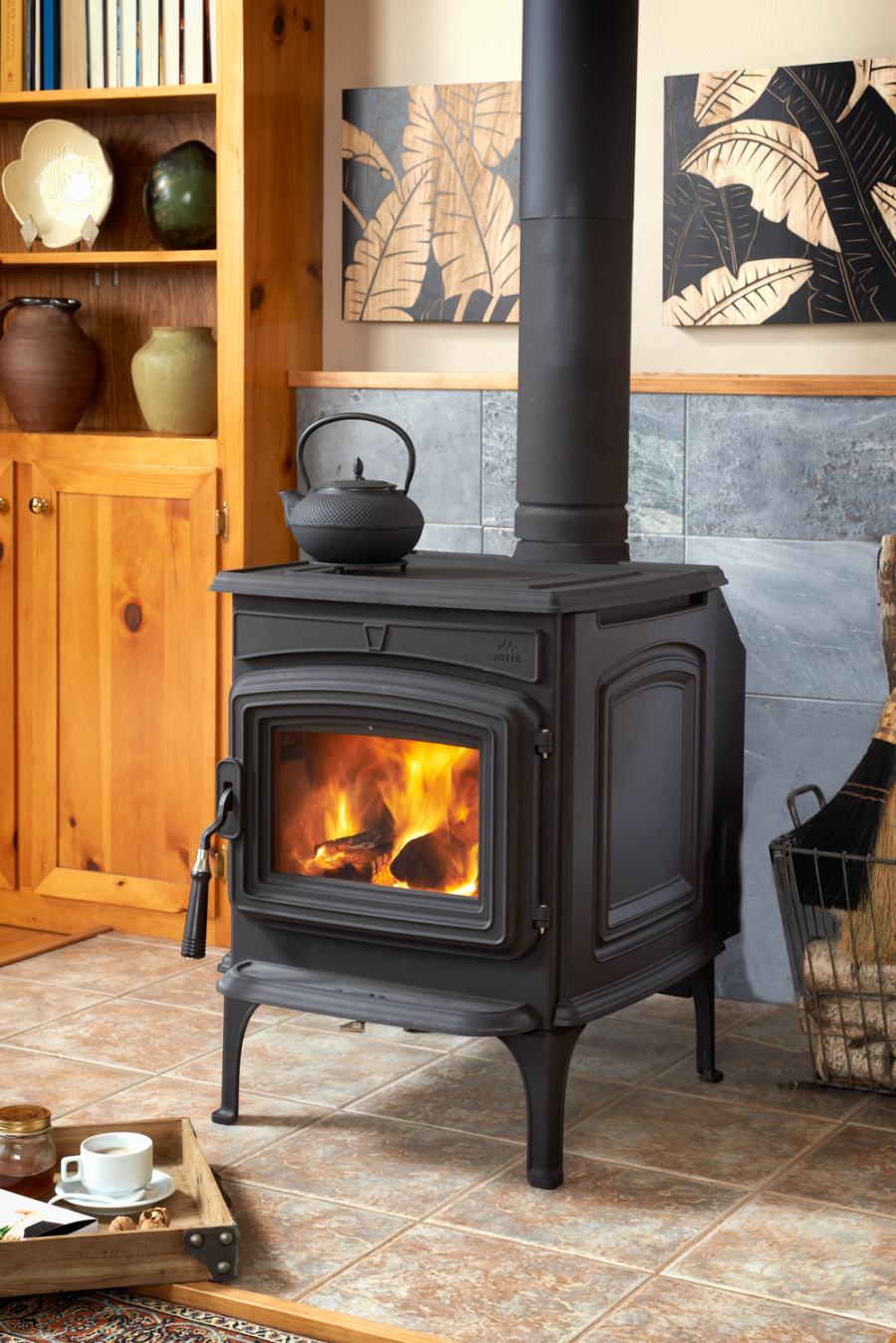 Wood stove in a small kitchen with a shelf behind it