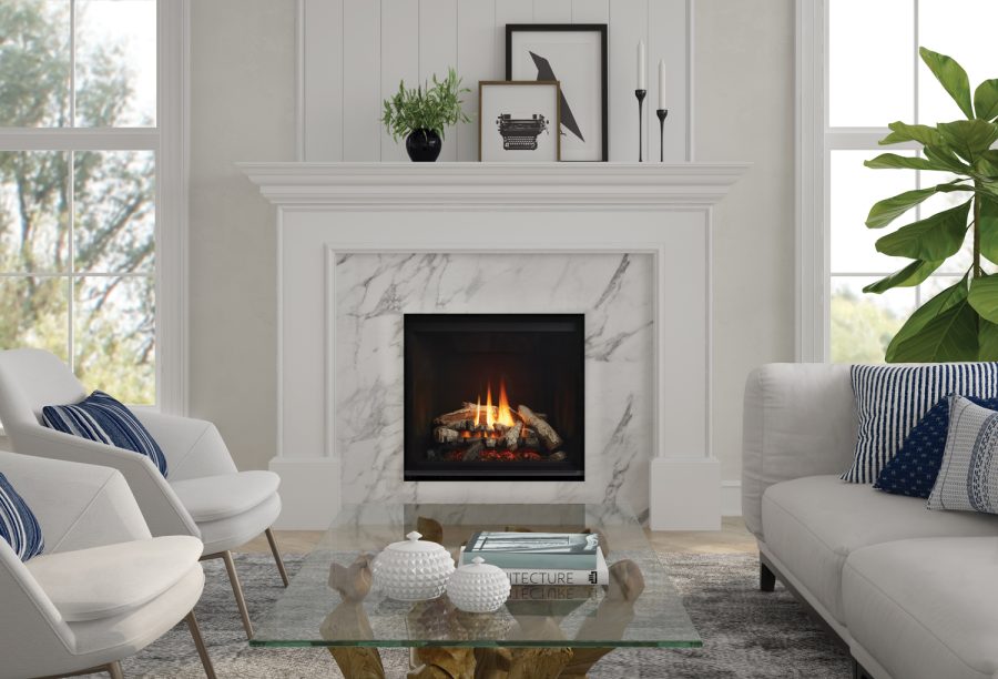 Fireplace insert with marble trim in a white room with plants and comfortable furniture