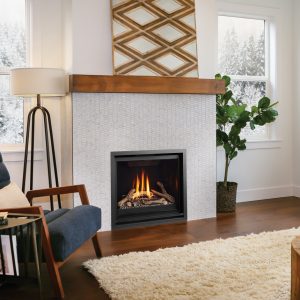 Gas fireplace insert in a white room with three windows and some furniture and fancy decorations