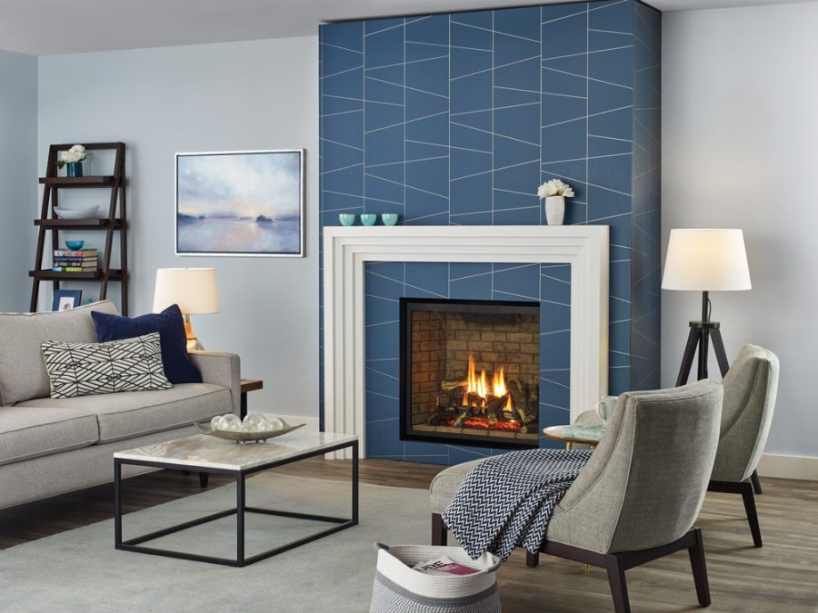 Fireplace insert with white frame and blue tiles in a modern home with furniture