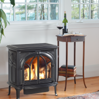 Large window above gas fireplace with a plant next to it