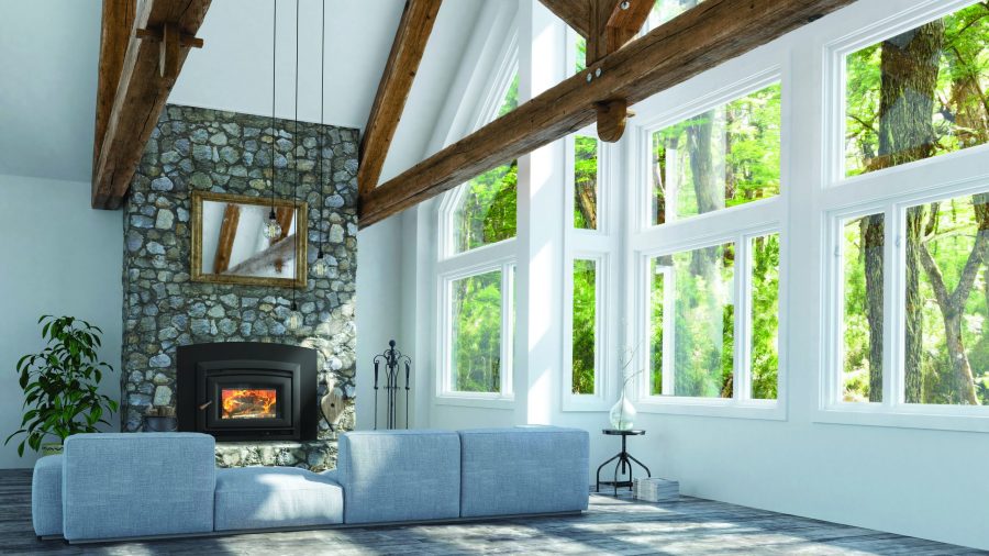 Wood stove insert in a large room with large windows and wooden open rafters