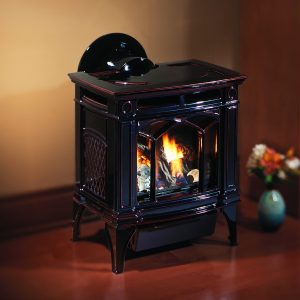 An elegant black gas stove against a wall in a dim room