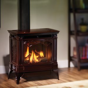 Beautiful gas stove in a living room with a warm fire going.