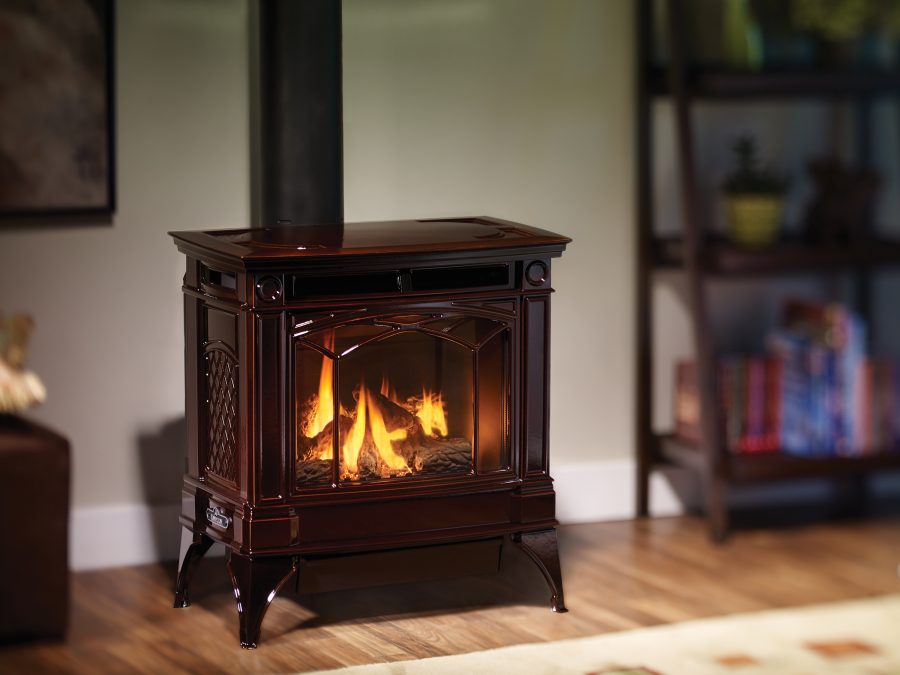 Beautiful gas stove in a living room with a warm fire going.