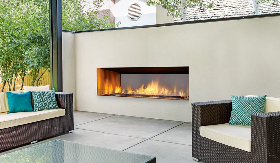 Modern outdoor fireplace insert built with white stone in a seating area with comfortable seating