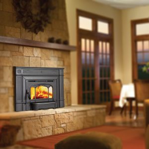 Wood fireplace insert in cozy dining room with large windows in the background