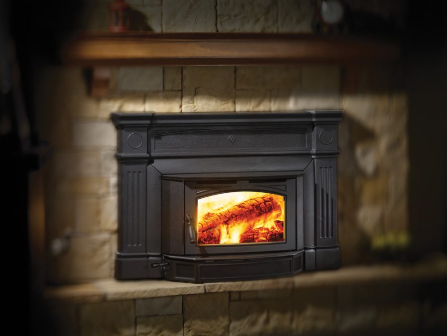 Fancy black wood fireplace insert with a cozy fire going inside