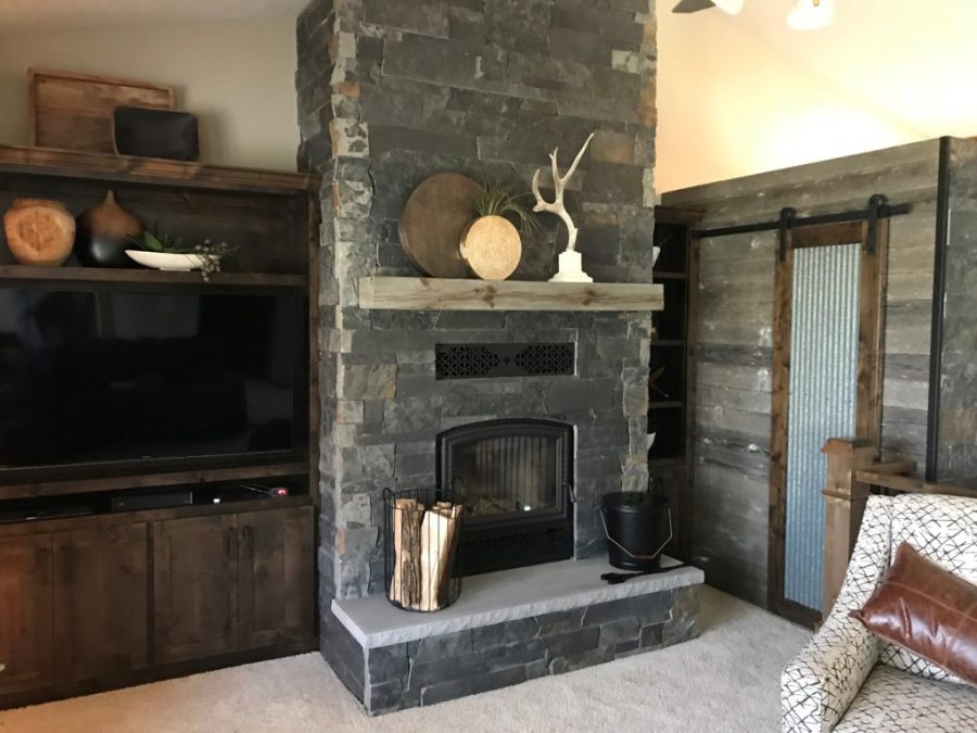 Fireplace with a stone surround in a small living room