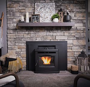 Black fireplace insert with a stone mantle and a warm fire going