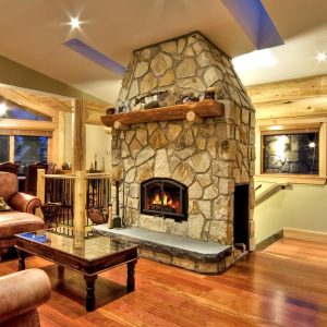 Fireplace in a large home with wooden supports and a sitting area