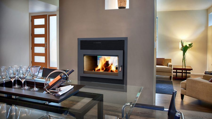 two sided fireplace in the middle of the modern home with a fire going