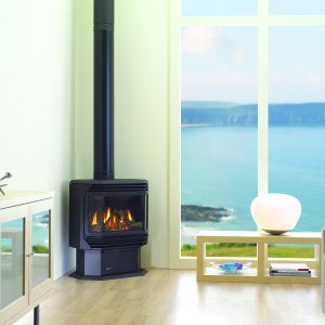 Modern black gas stove in front of large window overlooking the sea