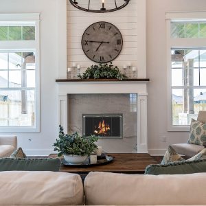 White living room with fireplace and two large windows