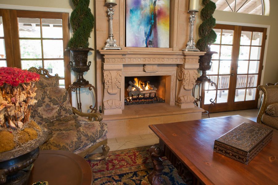 Fancy fireplace in a dining room with a fire going