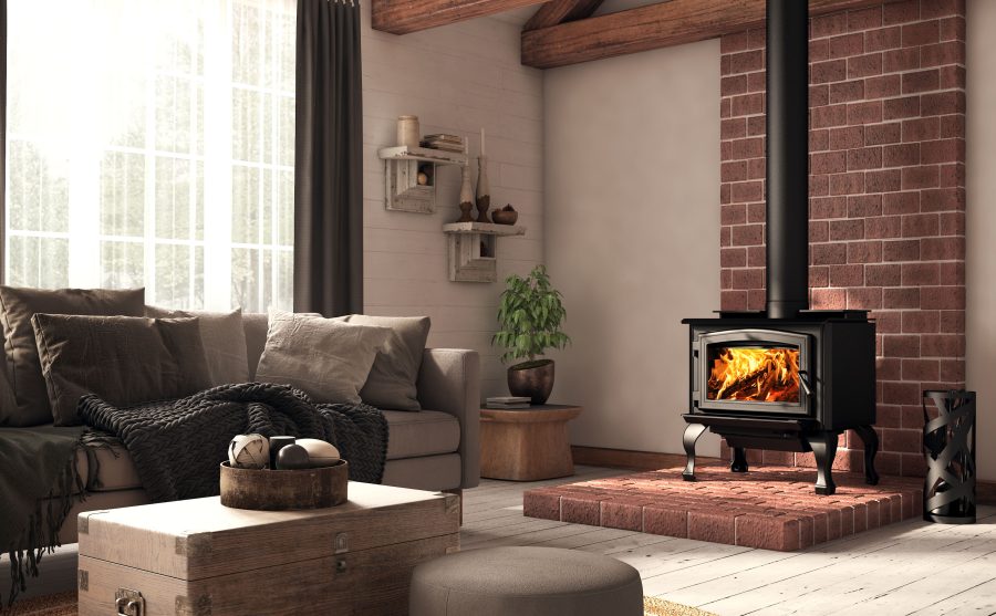 Small black fireplace in a living room with a windows brick chimney and couch