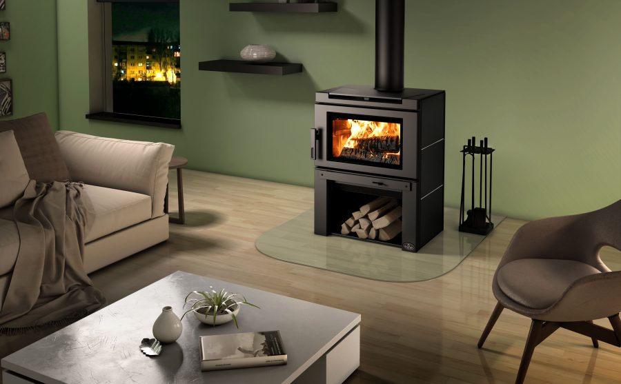 Futuristic looking wood stove with a green wall behind it and some furniture