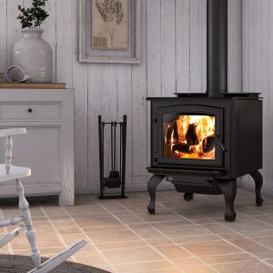 Small wood stove in a white room with white floors and white decorations