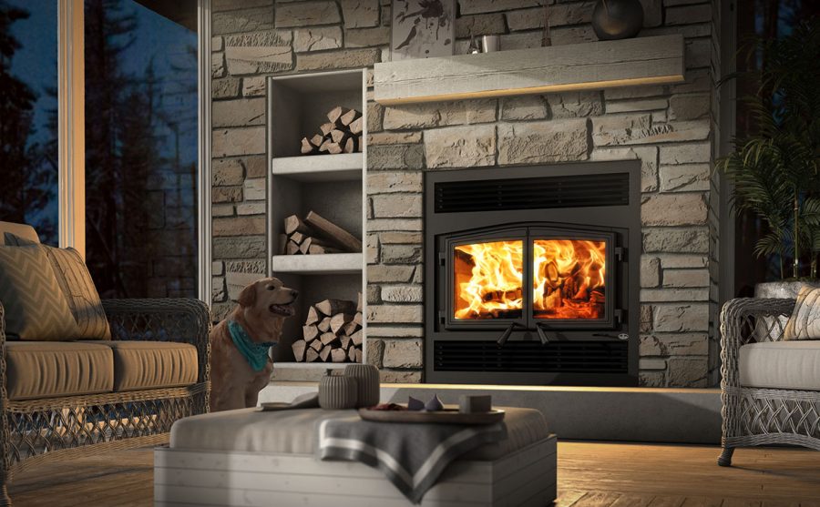 Wood fireplace in a cozy home with a fire going with a stone surround