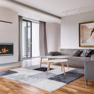 Fireplace in a modern home with wood floors and grey walls