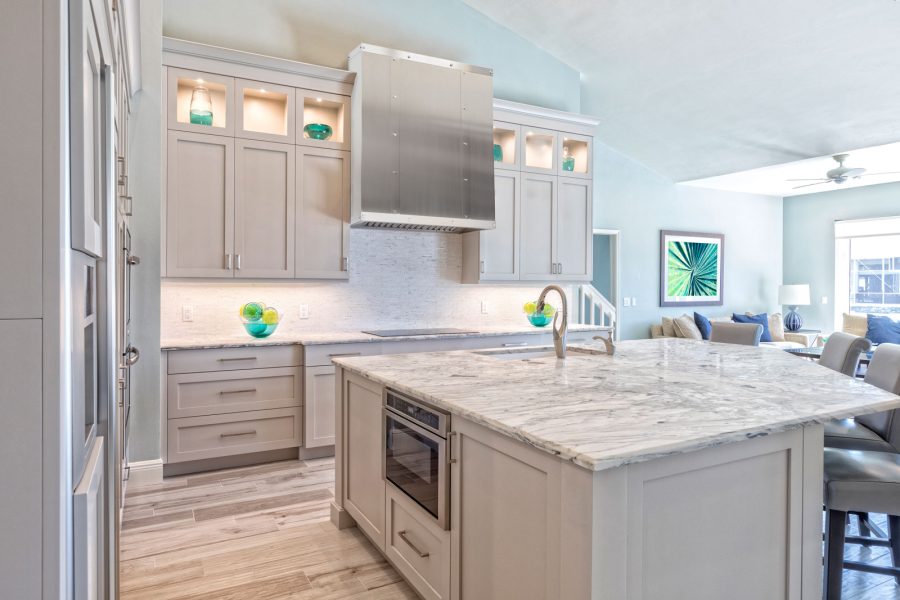 Modern white kitchen with a steel range hood