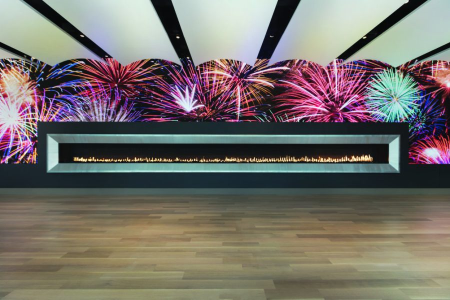 Long linear fireplace with a wall behind it covered in a picture of fireworks